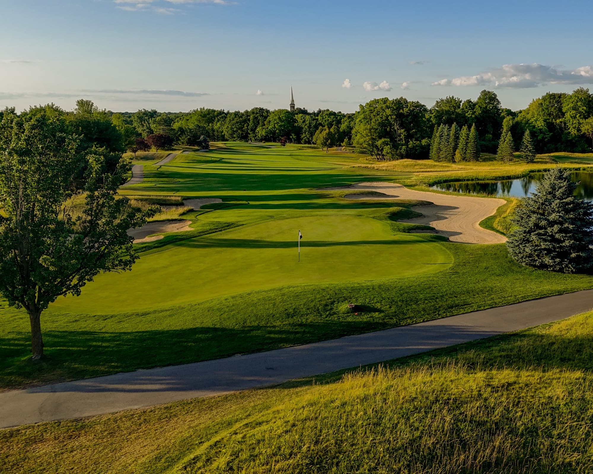 Fairway at The Fortress running toward the Frankenmuth church steeple in summer evening light