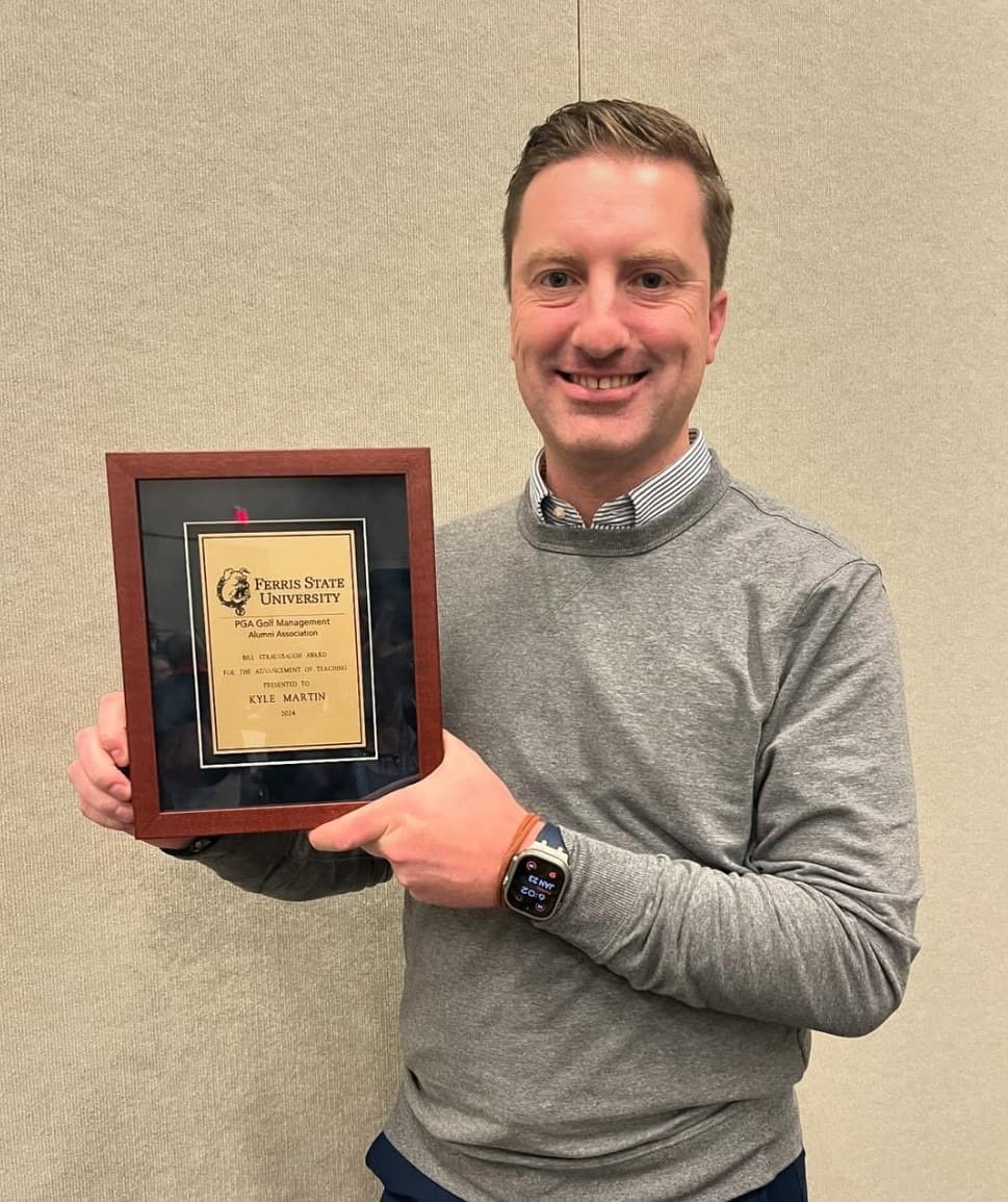 Kyle Martin, PGA, Head Golf Professional at The Fortress, holding a framed award